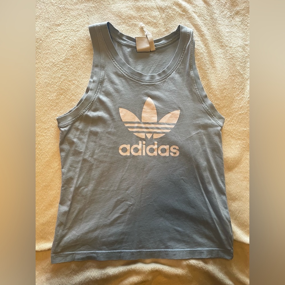 Men’s light blue Adidas tank tops.